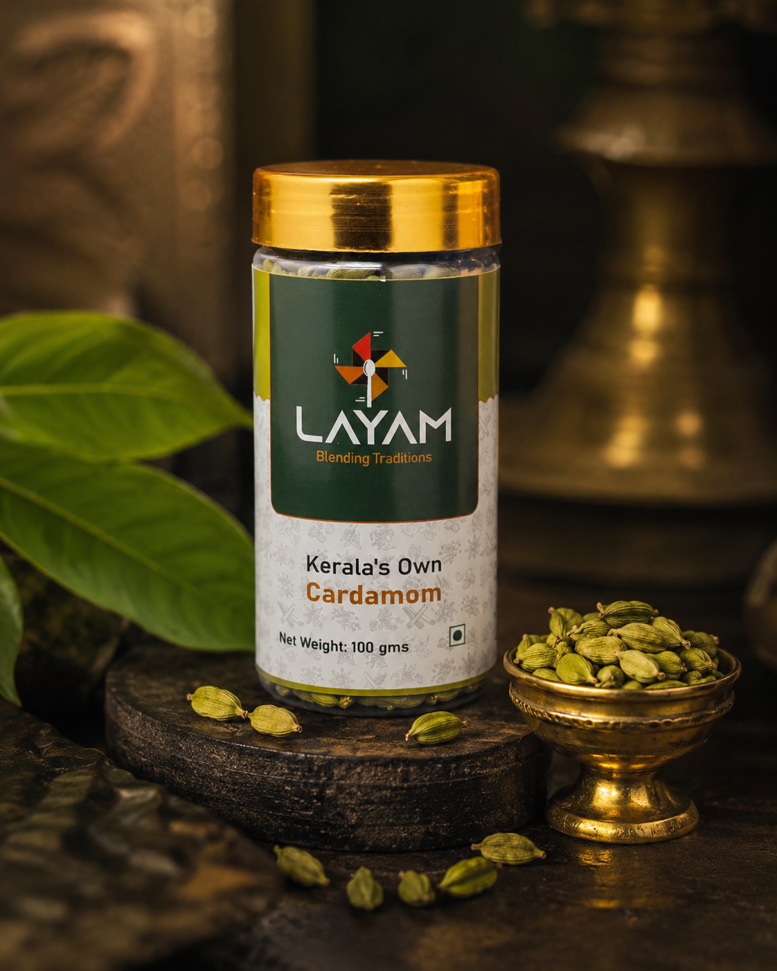 LAYAM Kerala's Own Cardamom jar, 100 g, with whole green cardamom pods in a brass bowl