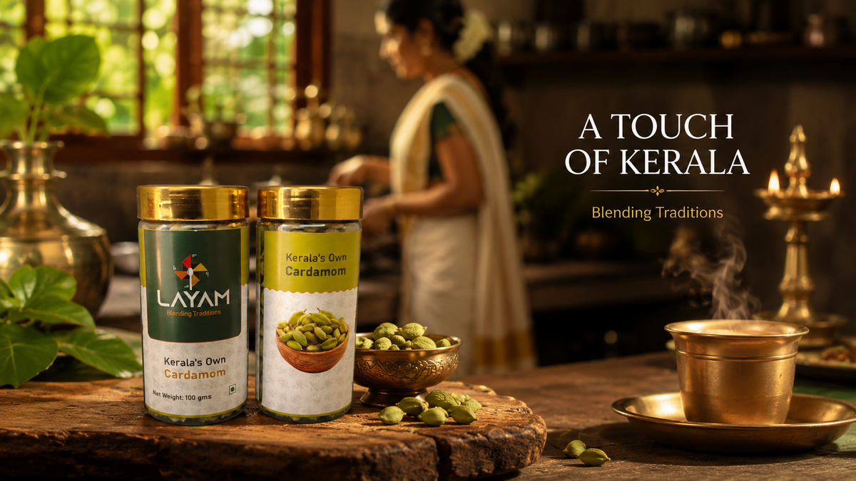 LAYAM cardamom jars in a traditional Kerala kitchen with brass vessels and a lit lamp