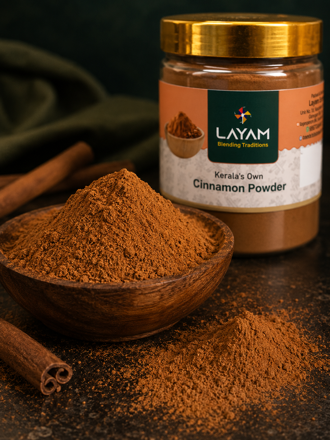 Close-up of fine LAYAM cinnamon powder in a wooden bowl beside the jar and whole quills