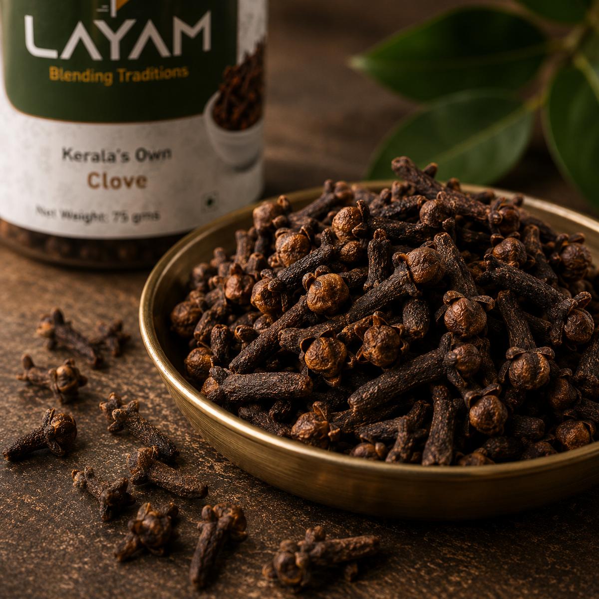Close-up of whole LAYAM cloves in a brass dish showing plump buds and intact stems