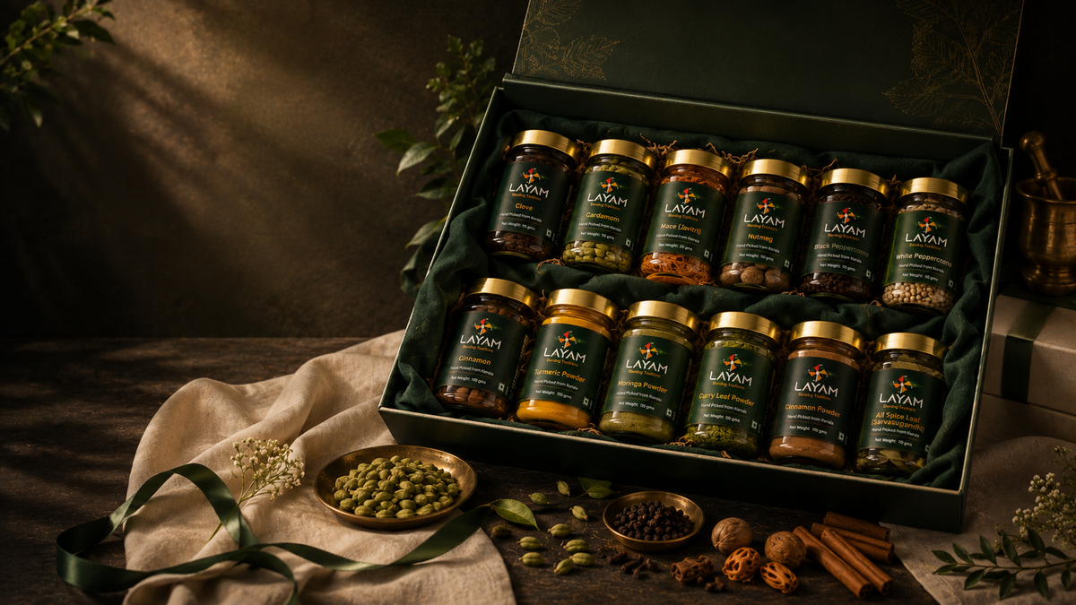 Open LAYAM gift box lined with green velvet holding twelve single origin Kerala spice jars