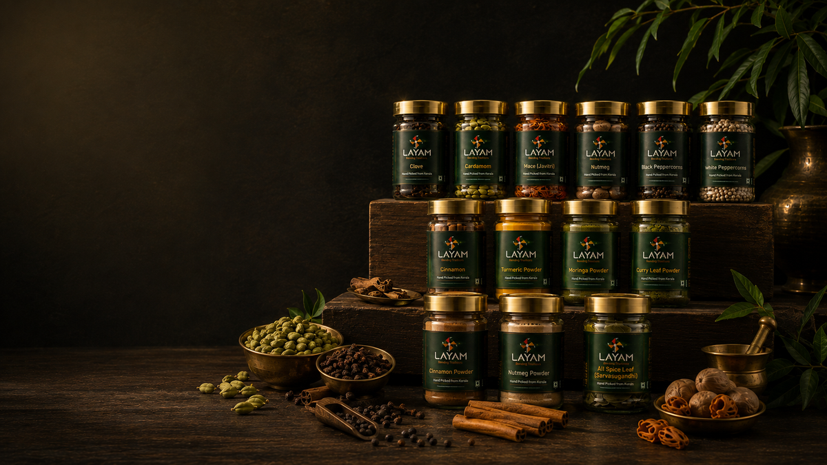 The full LAYAM range of thirteen single origin Kerala spice jars arranged on dark wooden steps