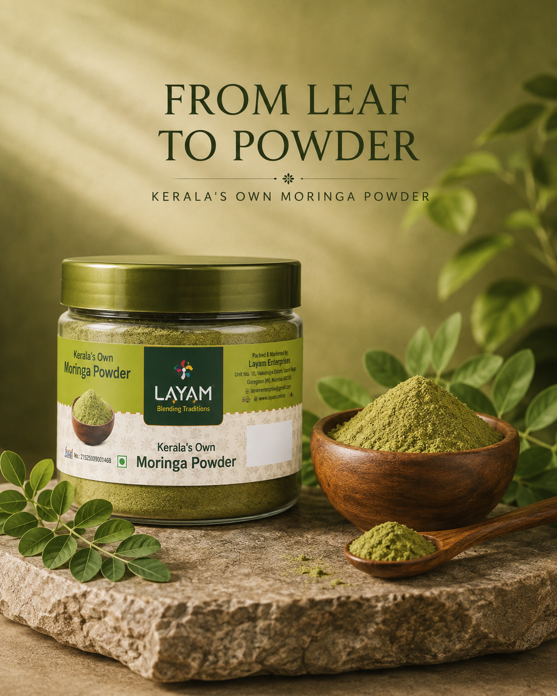 LAYAM moringa powder jar on stone with a wooden bowl of powder, a spoon and fresh moringa leaves