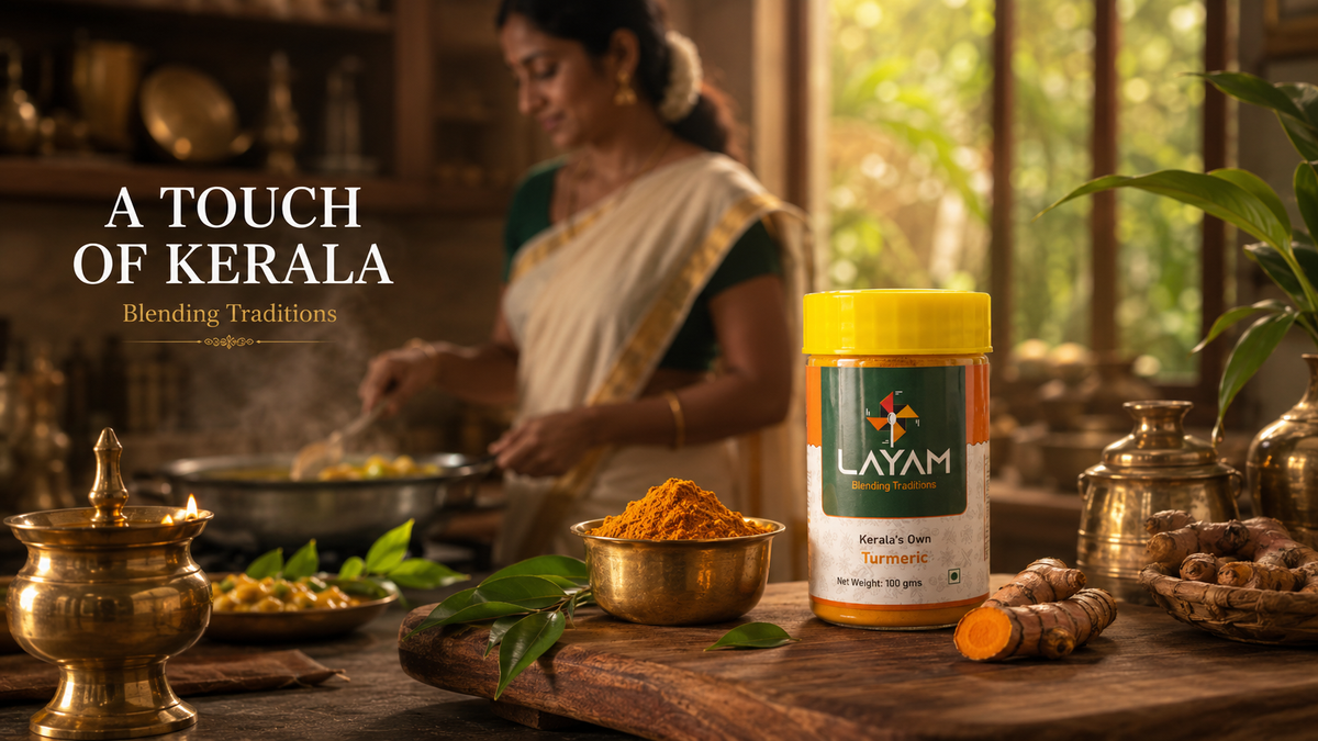 LAYAM turmeric jar in a traditional Kerala kitchen with brass vessels and a lit lamp