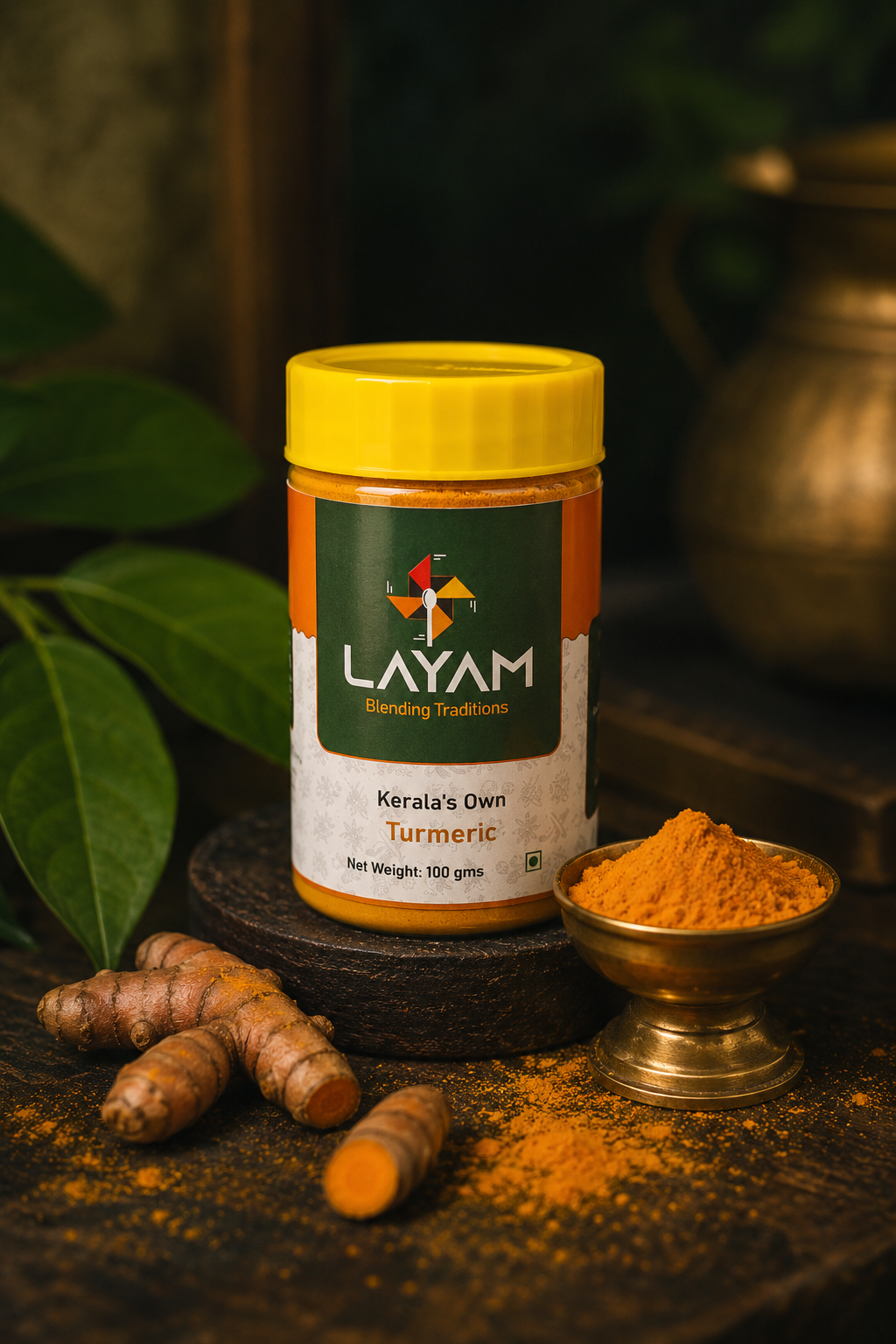 LAYAM Kerala's Own Turmeric jar, 100 g, with a brass bowl of powder and fresh turmeric root