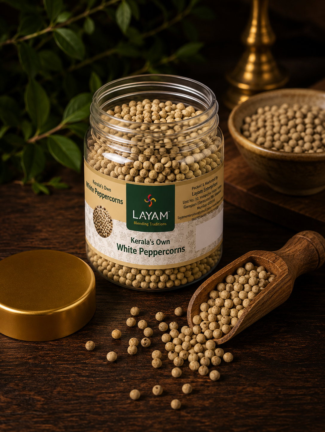 Open jar of LAYAM White Peppercorns with a wooden scoop